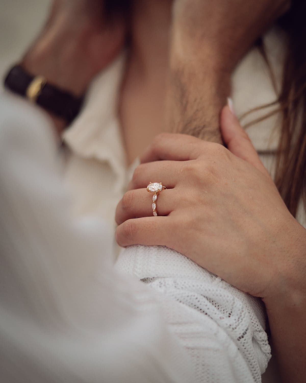 Close-up of an oval diamond engagement ring on a woman's hand during proposal photography at Jervis Bay NSW.